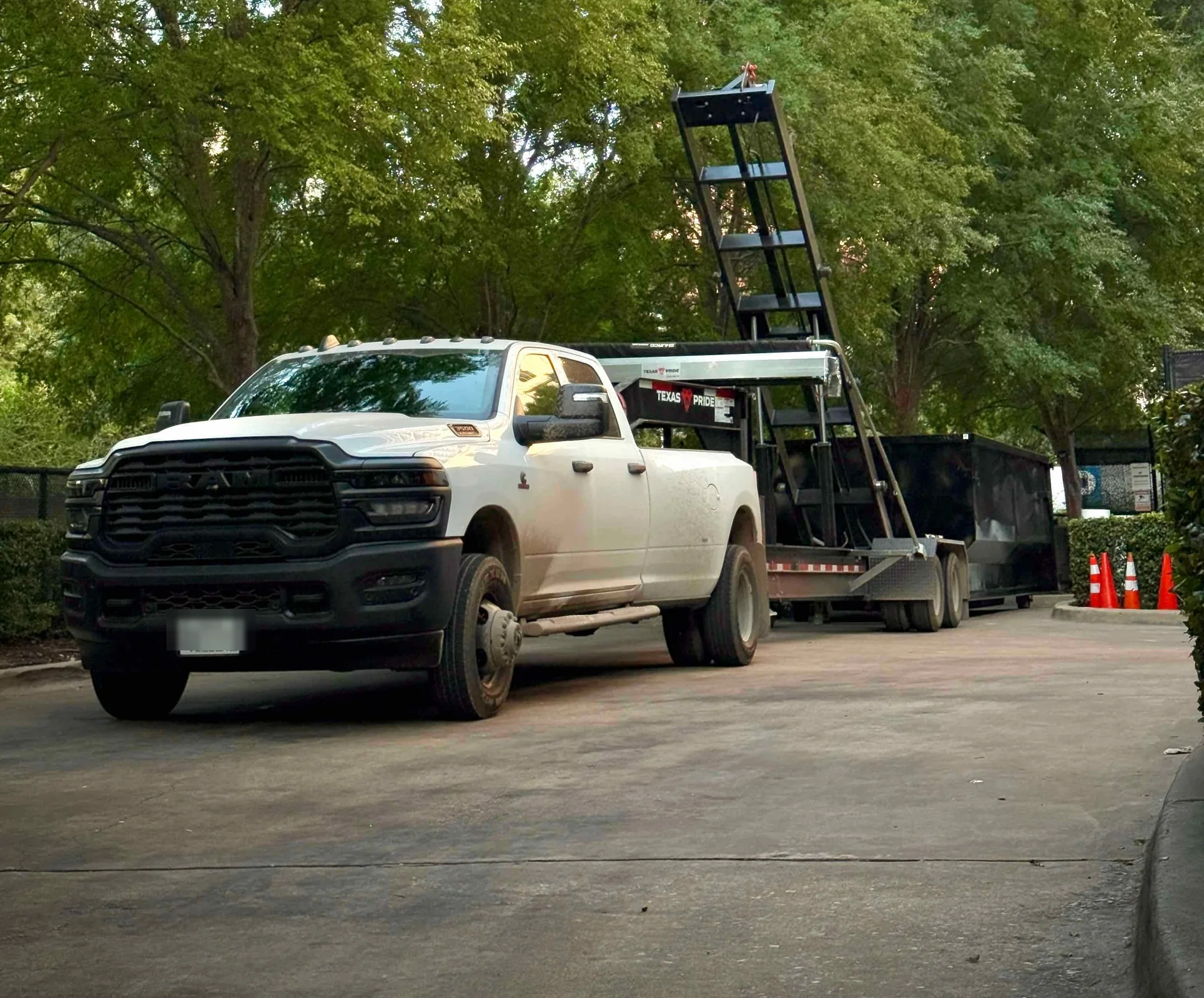Nortex truck and hooklift trailer delivering a dumpster